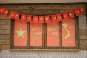 Indoor display of Vietnamese flags and a map highlighting national unity symbols.